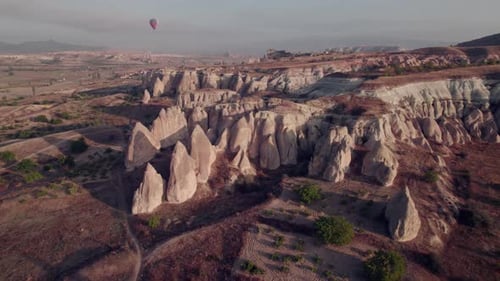 Aerial view of Cappadocia’s fairy chimneys and balloons