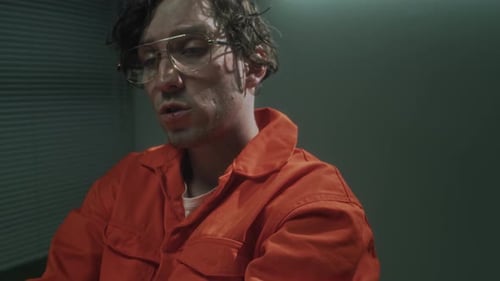 Man in Handcuffs in Orange Jumpsuit