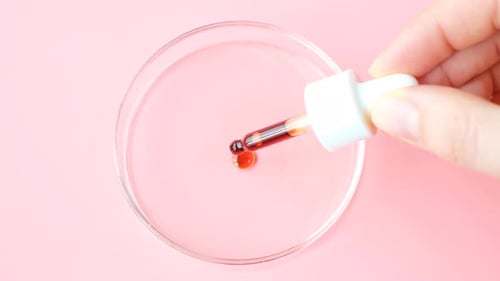 Dropping Liquid into Petri Dish for Scientific Research