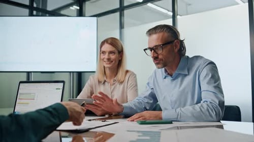 Business People Discussing Data at Conference Table Meeting