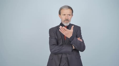 Man Gesturing Expressively Wearing a Gray Business Suit