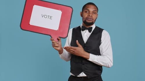 Man Holding Vote Sign on Blue Background
