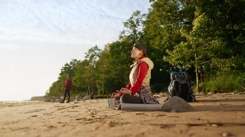 Enjoy Silence and Calmness Woman Tourist Meditating on Sea Shore After Hiking Halt on Coastline