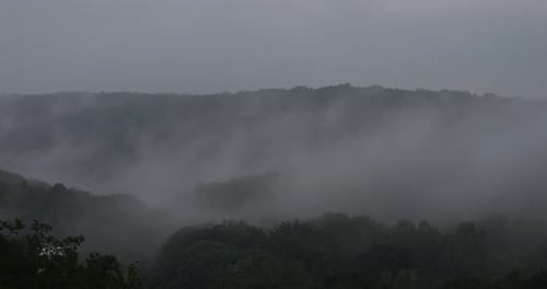 Fog over the forest in the mountains. Time lapse.