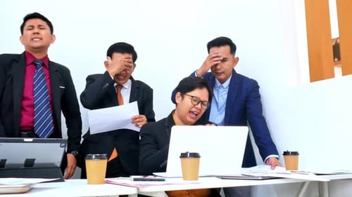 Frustrated team in meeting struggles with difficult project showing stress and pressure