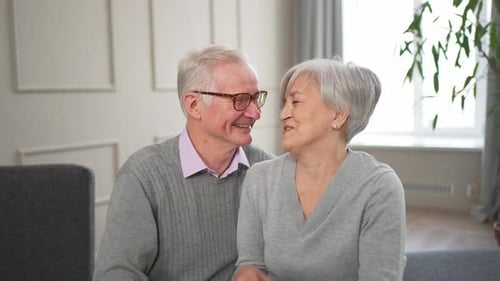 Loving Senior Couple Smiling Together at Home