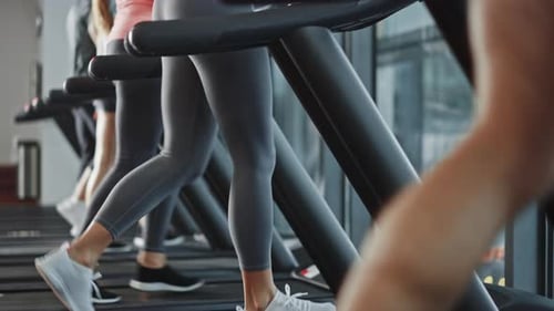 Beautiful Athletic Sports Woman Wearing Wireless Headphones, Listens to a Podcast or Sport Music Pl