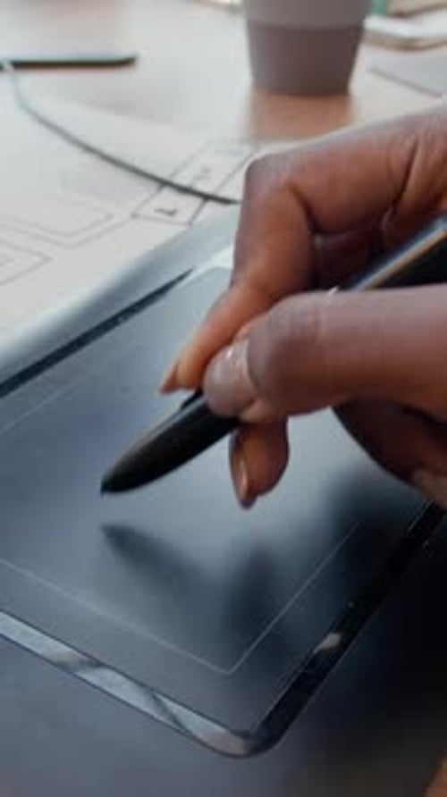 Vertical of Female Hand Drawing on Graphics Tablet Designing App at Office