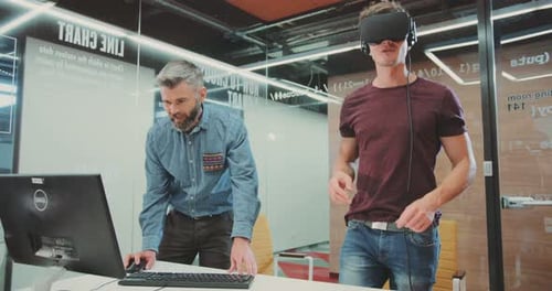 NEW YORK April 5 2017Stylish Attractive Guy in Virtual Reality Glasses Examining Office Smiling