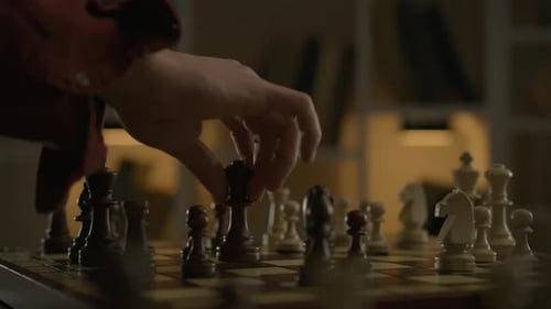 A cinematic shot of a chess player making a move with the queen chess piece. Chess game an