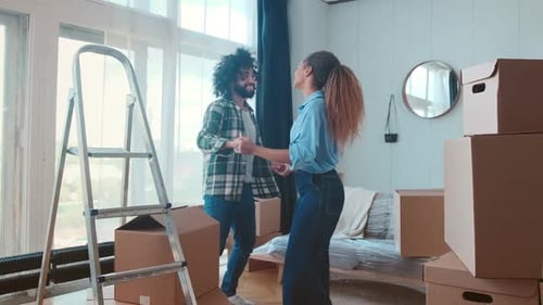 Happy Couple Dancing in New Apartment