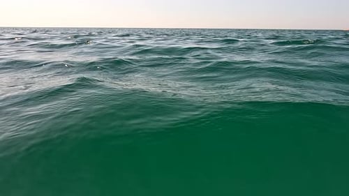 Sea Water Surface Low Angle View From Kayak Camera Flies Over the Clear Green Sea Water Nobody
