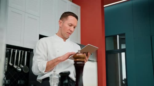 Chef Uses Tablet in Modern Kitchen