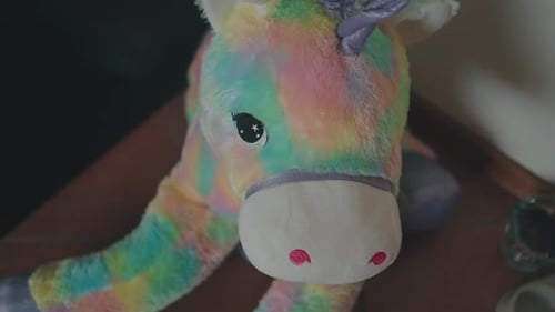 Rainbow plush unicorn toy close-up