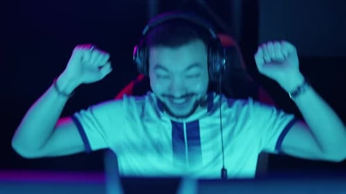 Excited Gamer with Headphones Playing Video Game