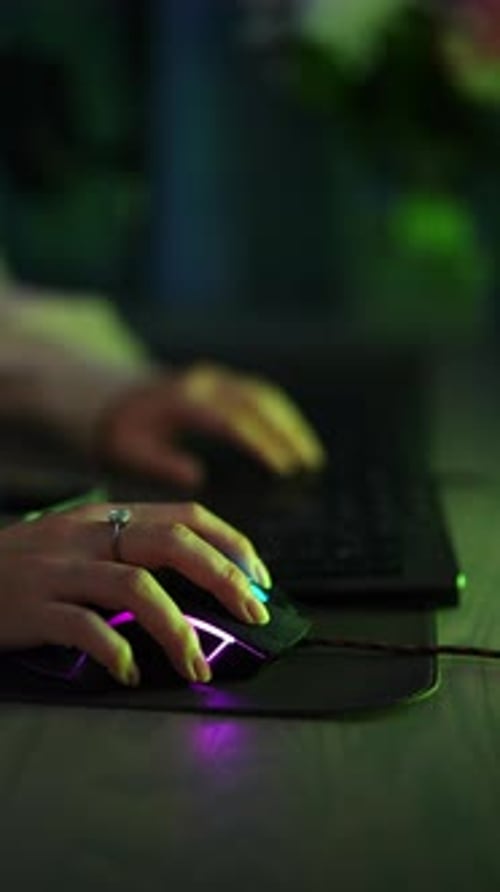 Woman Using Computer Mouse at Night, Portrait View