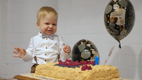 Cute Child Smiles Near Cake With Balloons Decorating