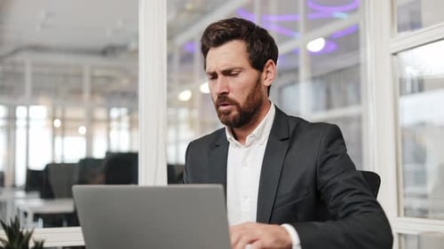 Adult Man Experiencing Back Pain While Working on Laptop