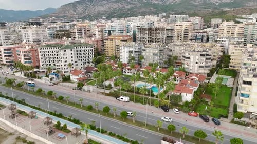 Aerial View A Stunning Vintage Villa Complex By the Sea with a Sparkling Pool and Tall Green Palm