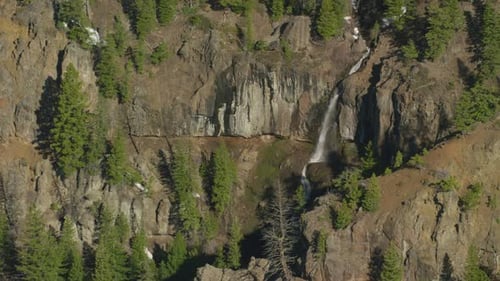 A Waterfall Cascades Over the Steep Cliffs in Central Yellowstone National Park Aerial