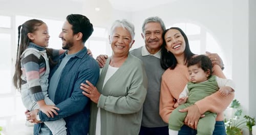 Smiling Multigenerational Family Posing Together in Bright Home