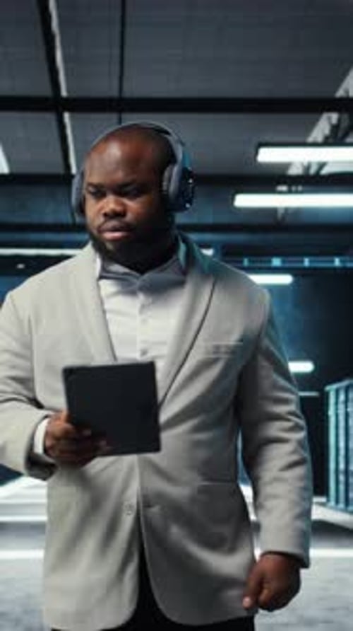Vertical Video Server Room Programmer Wearing Headphones Troubleshooting Errors