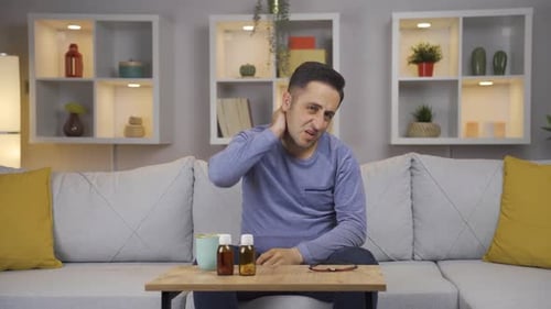 Sick man suffering from neck pain.
