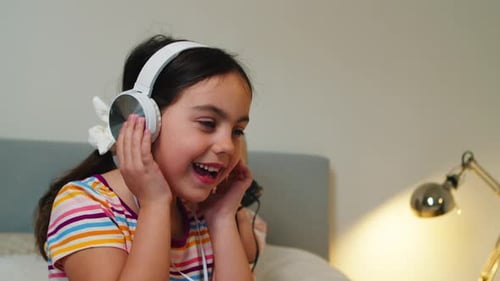 Happy Child Listening to Music with Headphones