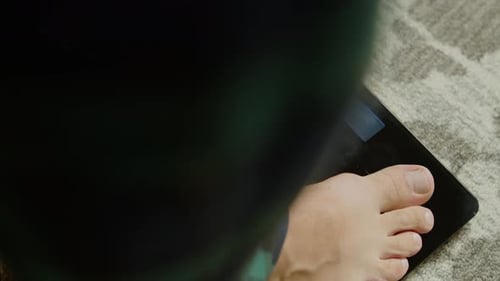 Weight Monitoring In Gym Male Athlete Stands On Digital Scales