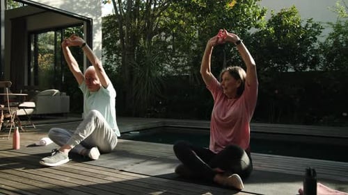 Mature Couple Doing Yoga at Home Outdoors