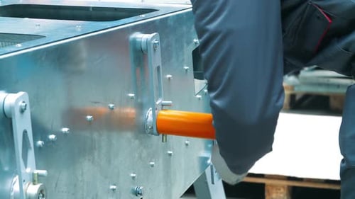 Worker Securing Bolts with Wrench with T-Handle. Using of Metal Handle Wrench