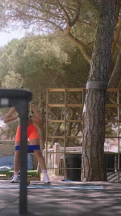 Young Woman Exercising with Resistance Band in Park