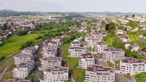 Luxury Apartment blocks with green green rooftop and solar panels. Production of green energy theme.