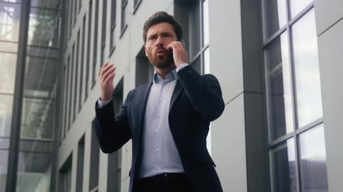 Angry Businessman Yelling on Phone Outside Office