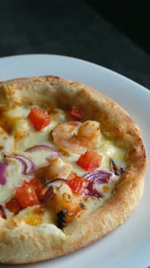 Delicious Seafood Pizza with Tomatoes and Onions