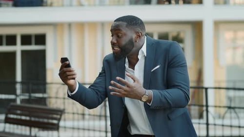 Angry African Businessman Feeling Stressed at Urban Street. African American Business Man