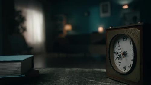 Vintage Clock Stands on a Table in a Dark Room Close Up The Clock Hand is Spinning Fast Time is