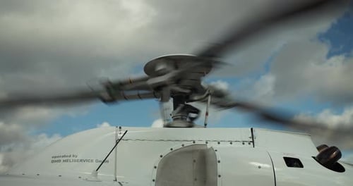 Close Up Footage of Rotating Main Rotor of Helicopter After Landing Engine Cover Roof and Rotor
