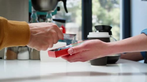 Closeup a Stylish Old Man Makes a Purchase in a Coffee Shop Pays with a Bank Card Technologies in