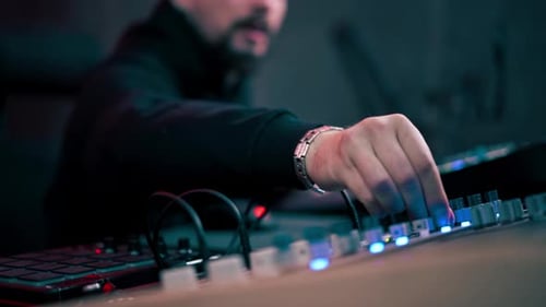 in the Recording Room Dark with Neon Lighting in the Studio the Sound Engineer Works at the Console