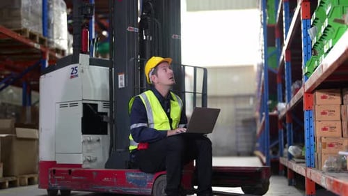 Warehouse Industrial and Logistics Companies. Dispatcher in uniform making inventory in storehouse.