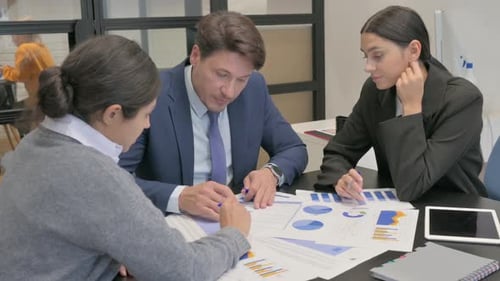 Business Professionals Analyzing Data in a Modern Office