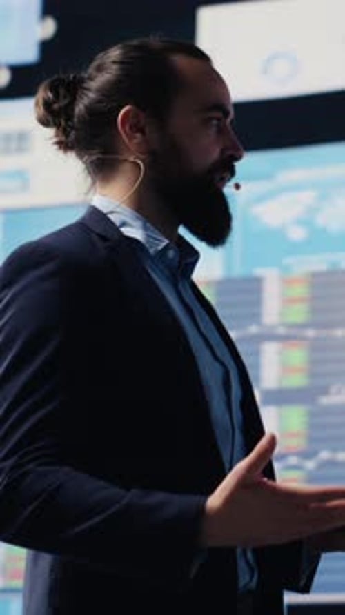 Man Giving Technology Presentation With Data Behind