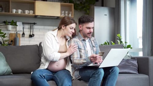 Pregnant Couple Shopping Online at Home