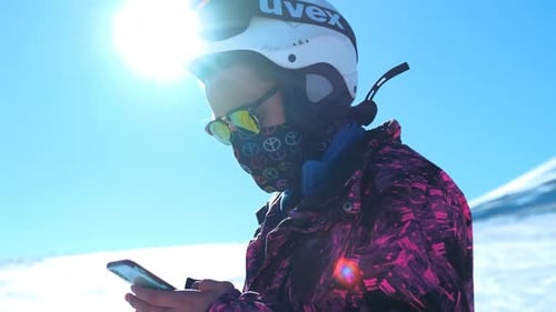 Woman Using Smartphone in Winter Outdoor Setting