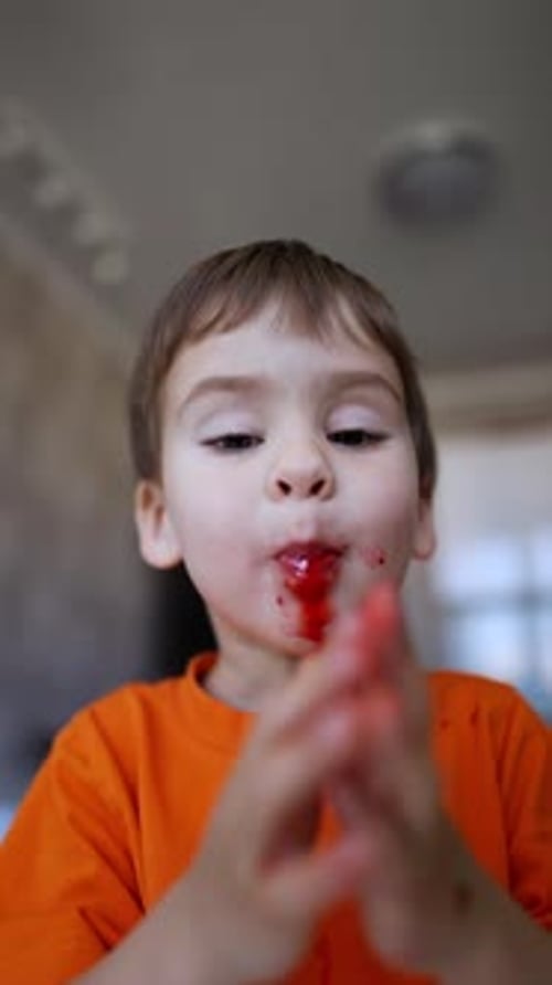 Joyful Child Eating Messy Food Indoors
