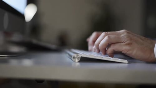 Hands on Keyboard. Businessman in His Office at Night
