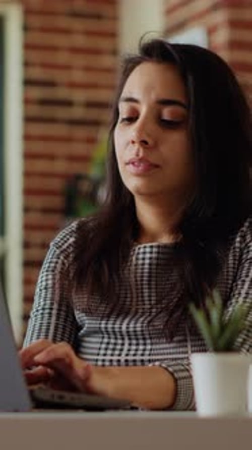 Woman Working at Laptop in Modern Office