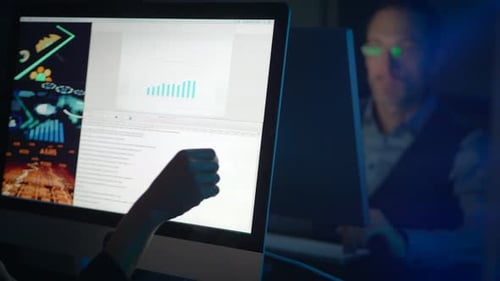 A Professional is Meticulously Analyzing Data Displayed on a Computer Screen in Detail