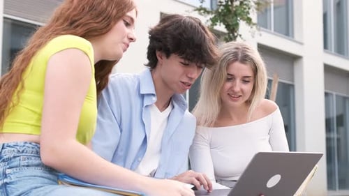 Smiling Young Friends Using Laptop Outside University Building